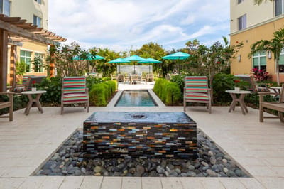Outdoor patio with seating and a water feature