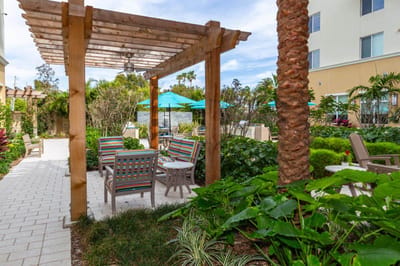 Outdoor seating area with colorful chairs and lush greenery