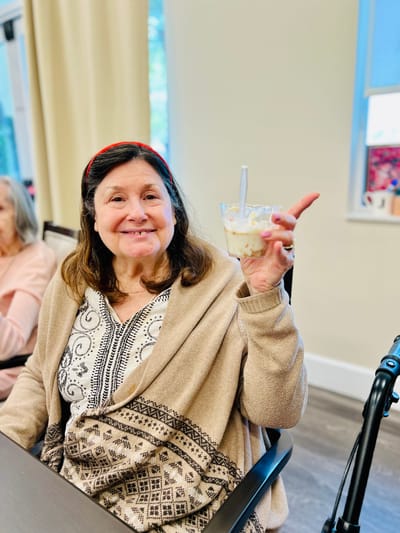 Resident enjoying dessert in a common area