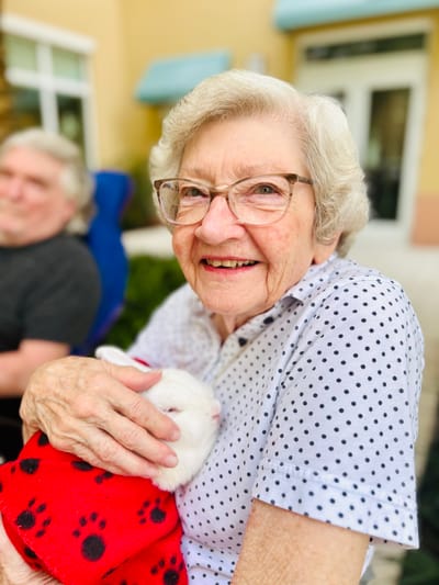 Senior resident lovingly holding a small rabbit