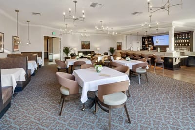 Elegant dining room with tables set for residents