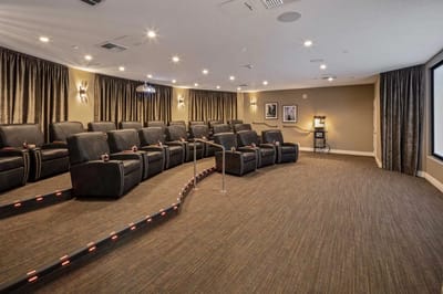 Interior view of a movie theater room with recliner seating