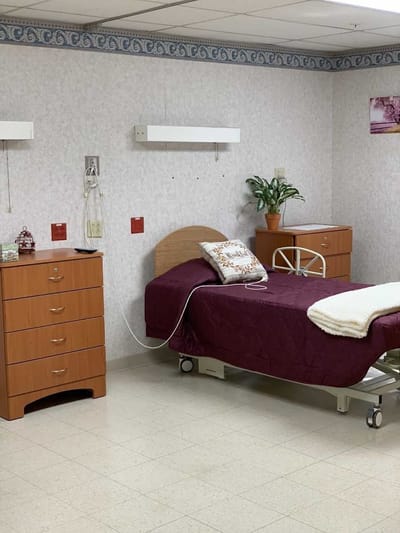 Private resident room with bed and furnishings