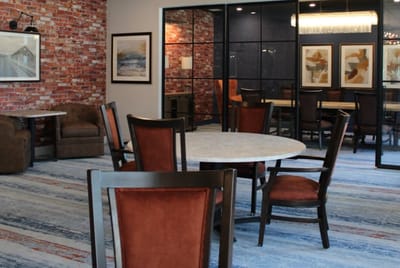 Common area with tables and chairs in a cozy setting