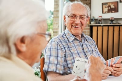 Meadowcrest – Middletown, Assisted Living in Middletown, DE — Two residents engaging in a card game indoors