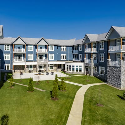 Aerial view of a senior living facility with landscaped grounds