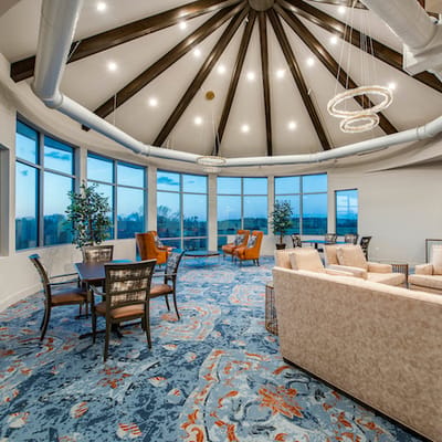 Bright common area with large windows and seating