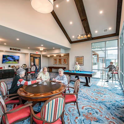 Residents engaging in a card game in a common area