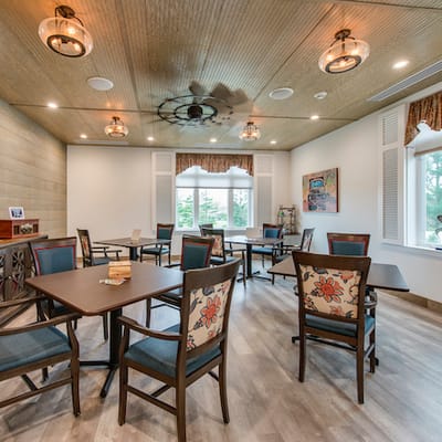 Brightly lit common area with tables and chairs