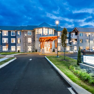 Exterior view of Meadowcrest facility entrance at dusk