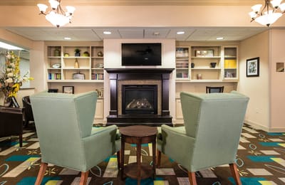Cozy common area with armchairs and a fireplace