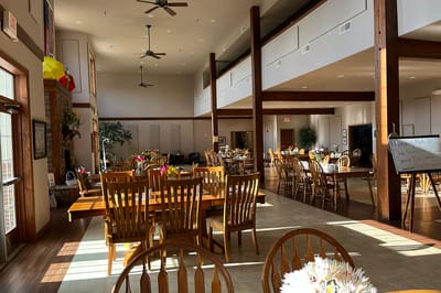 Dining area with wooden tables and flowers