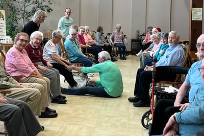 Seniors enjoying a seated activity in a common area.