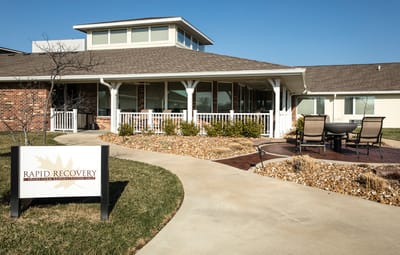 Exterior view of a recovery facility with signage.
