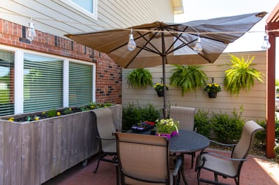Cozy outdoor patio with seating and plants.