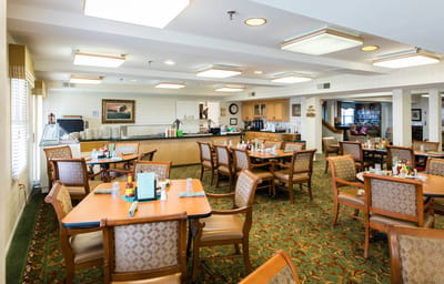 Dining area with tables and chairs in a communal space.