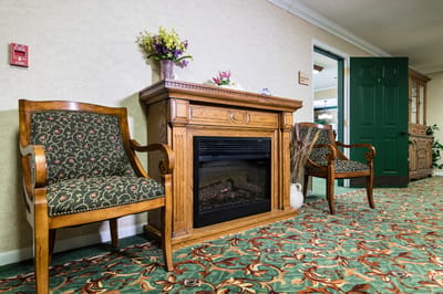 Cozy lounge area with fireplace and chairs