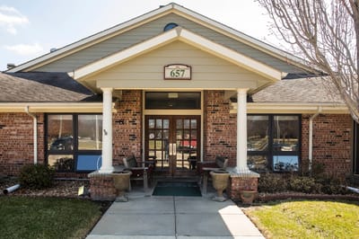 Front entrance of a facility with stone facade and porch