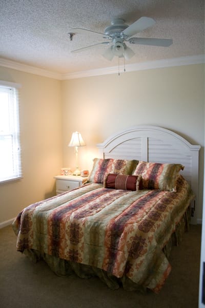 Cozy bedroom with decorative bedding and lamp