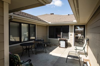Outdoor seating area with tables and chairs.