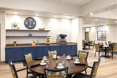 Dining area with tables and coffee station.