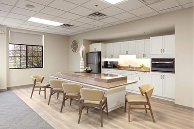 Bright common area with kitchen and seating.