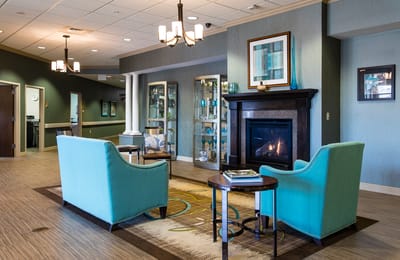 Cozy lobby area with seating and fireplace.