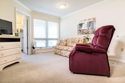 Cozy living room with floral couch and recliner