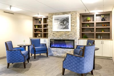 Cozy common area with stone fireplace and seating