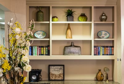 Decorative shelf with books and vases in a common area
