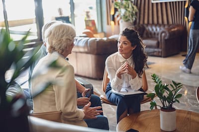 Staff engaging with residents in a comfortable lounge area.