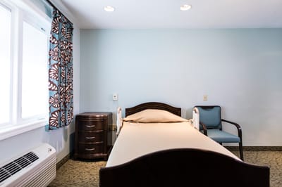 Cozy private room with bed and chair