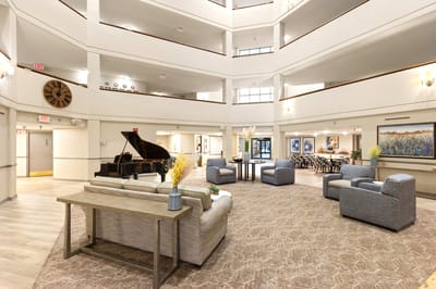 Spacious common area with seating and a grand piano