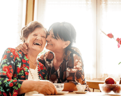 A joyful interaction between a resident and staff member.