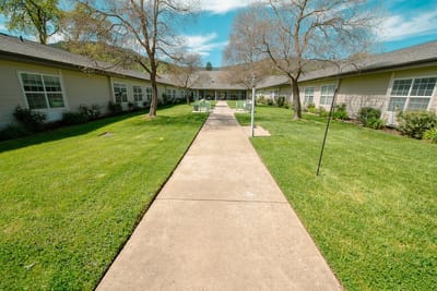 Pathway leading to residential facility with outdoor space.