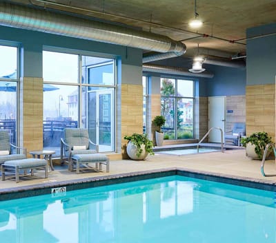 Indoor swimming pool area with seating