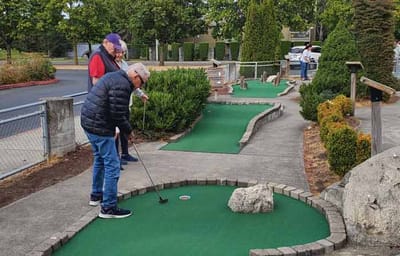 Residents playing mini-golf outdoors