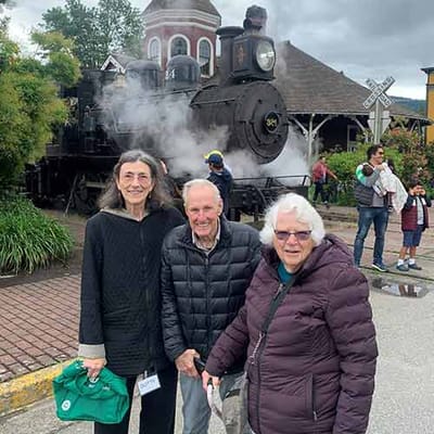 Three residents enjoying a day out near a steam train.