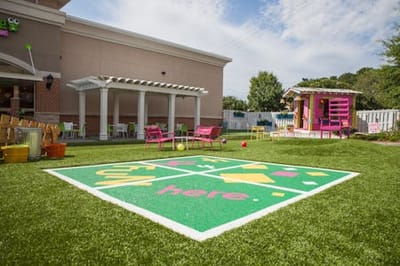 Colorful outdoor play area with grass and seating