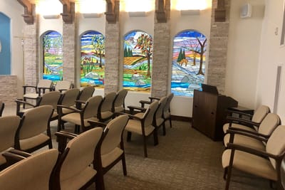 Interior chapel with stained glass windows and seating
