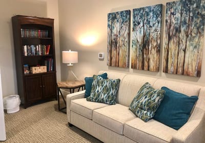Cozy interior space with furniture and artwork.