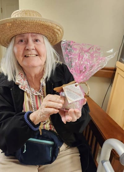Senior woman holding a decorated gift