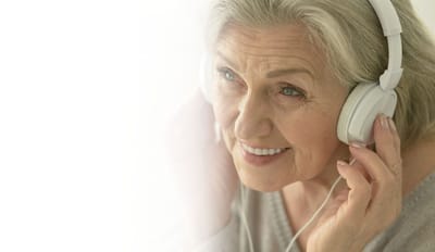 Elderly woman listening to music with headphones