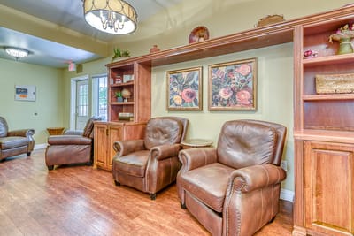 Cozy common area with leather chairs and floral decor