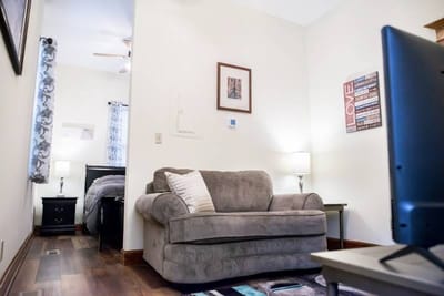 Cozy living space with a couch and lamps.