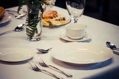 Elegant dining setup with plates and silverware.