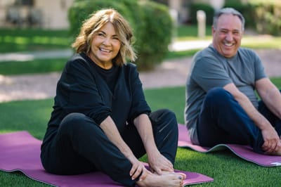 Two residents engaging in outdoor yoga