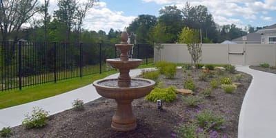 Outdoor garden with a fountain and landscaping.