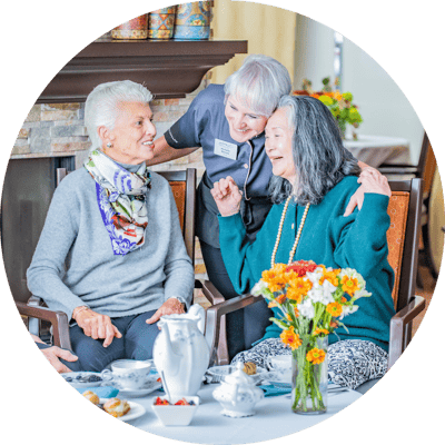 Residents enjoying interaction with staff in a cozy setting.