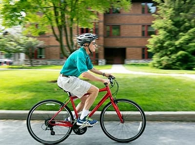 Senior man cycling near the facility